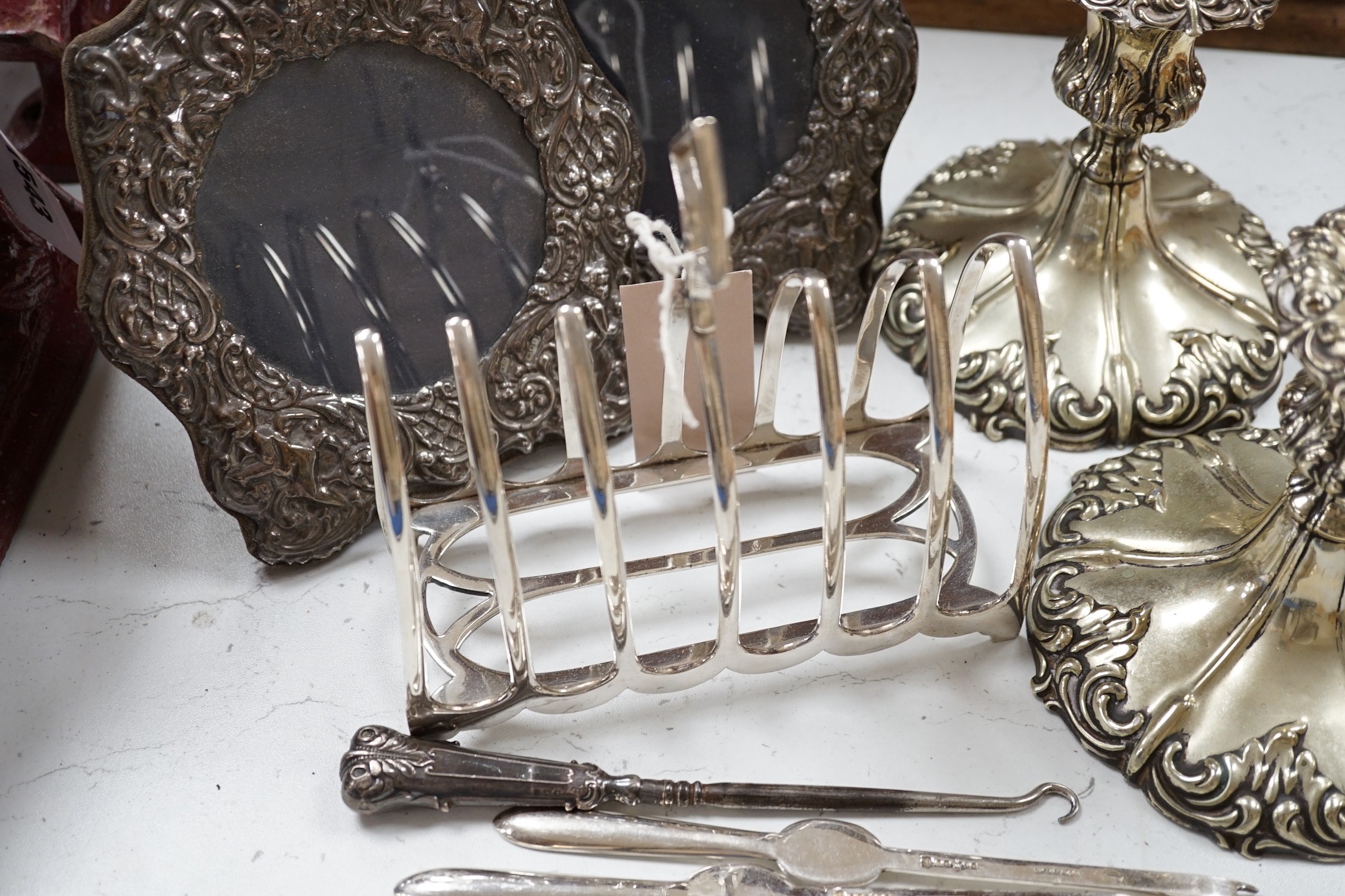 A pair of embossed silver photograph frames and plated wares